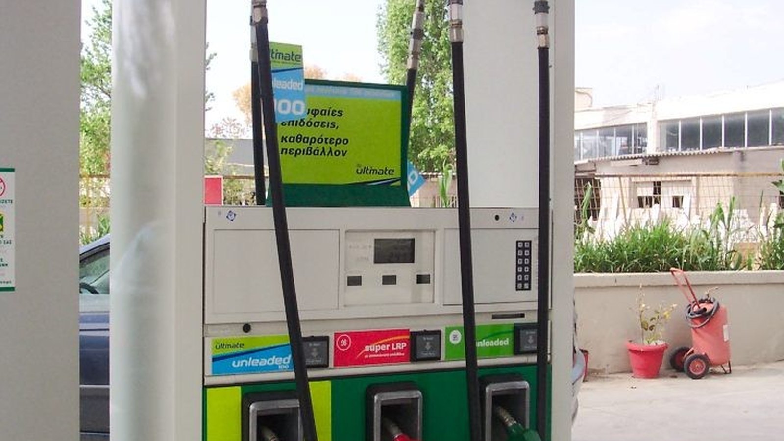 Close-up of a navy and ivory gas pump nozzle resting in its cradle