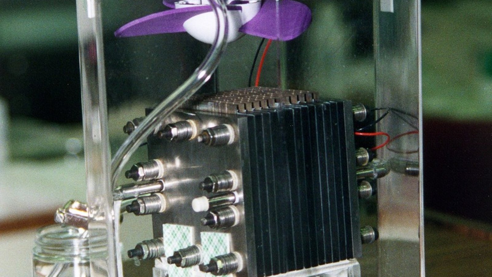 Hydrogen fuel cell power unit with heavy cables on a golf course beside a broadcast compound